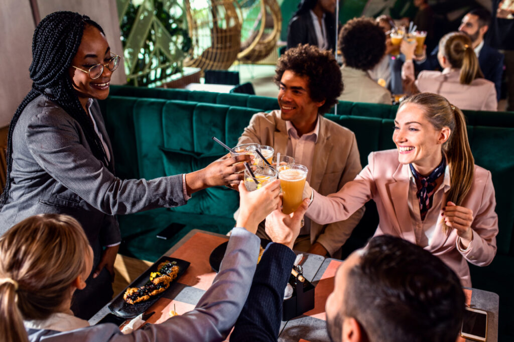 Group of businesspeople in a restaurant toasting at business lun
